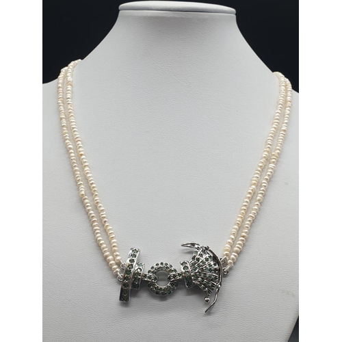 290 - 65 Ct Beaded Pearl necklace with a Silver pendant adorned with emeralds. Length: 49cm