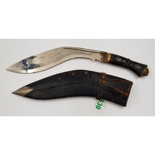 297 - A vintage kukri knife with gilded lions head, on handle and decorative engraving on blade. Comes wit... 