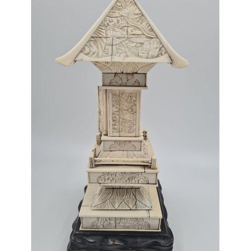 149 - A 19th Century Japanese Ivory Shrine (Meiji Period). The Pagoda top carved in low relief with decora... 