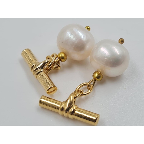 451 - A Pair of Pearl Cufflinks. Gilded metal attachments.