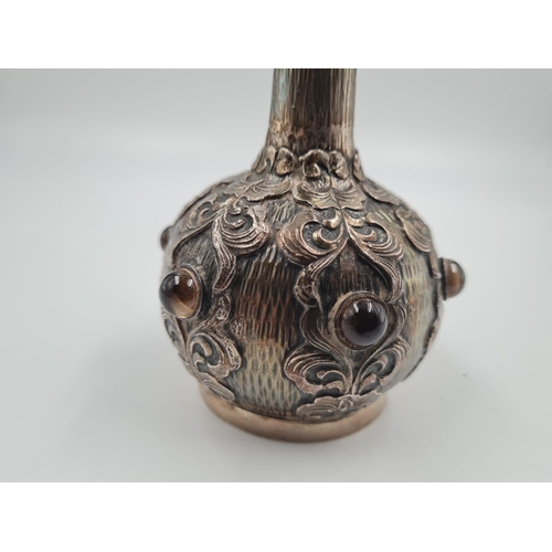 58 - AN ANTIQUE SILVER ORIENTAL VASE DECORATED WIT AGATE STONES, 18CMS TALL AND WEIGHING 234GMS
