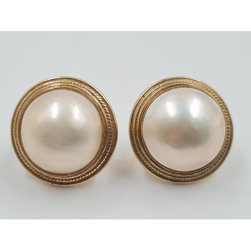 694 - A Pair of 14ct Gold and Pearl Earrings. Circular design. 2cm diameter. 9.3g total weight.