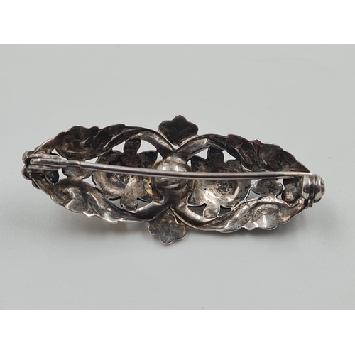 701 - 2 Silver Marcasite Brooches. One with a large Hamethyst the other a Pearl. 4cm. 18g total weight.