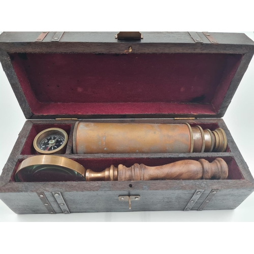 71 - An antique explorer’s basic kit including a compass, a 4 draw telescope and a magnifying glass, in a... 
