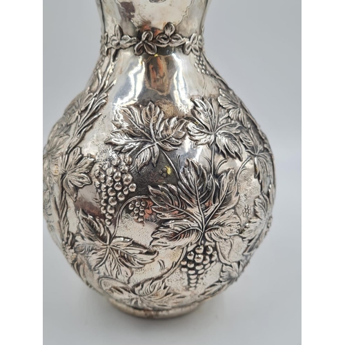77 - A LARGE SPANISH SILVER WATER JUG HAND FASHIONED CIRCA 1920. 474.4 gms and 27cms TALL
