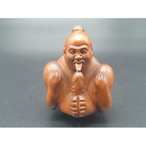 163 - An intricately carved boxwood, Japanese, netsuke of a contortionist man indulging in self-satisfacti... 