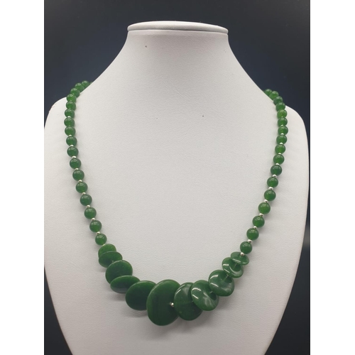 170 - A modern spinach green jade necklace, bracelet and earrings set in a presentation box. Necklace leng... 