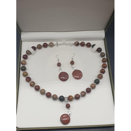 64 - A rare silver and jasper necklace and earrings set with fossil red horn corals (300 million years ol... 
