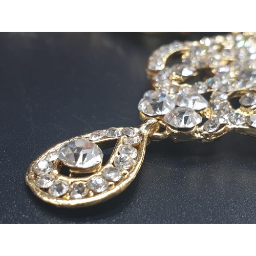 728 - A boxed set of a statement yellow metal triple ring and earrings with cubic zirconia. Ring size: N, ... 