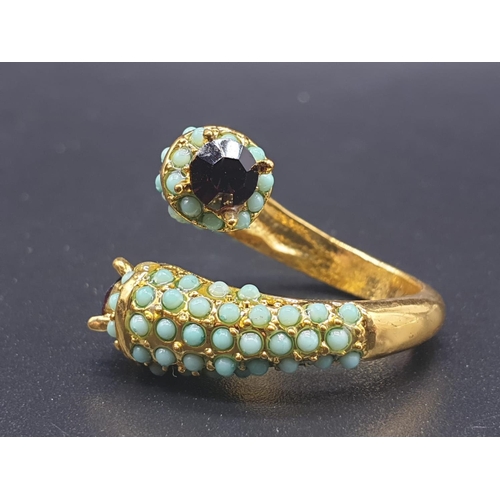 734 - An unusual yellow metal (untested) ring with turquoise and amethysts in its presentation box. Ring s... 