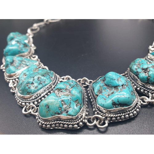 392 - A necklace and bracelet set with naturalistic large turquoise cabochons. In a presentation box. Neck... 