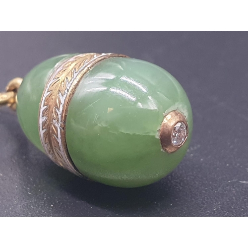 100 - A RUSSIAN 14CT GOLD AND JADE EGG PENDANT WITH A DIAMOND SET IN THE BOTTOM.3.5gms and 1.5cms