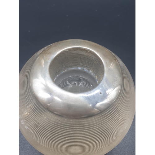 114 - AN ART DECO ASHTRAY/CANDLE HOLDER MADE IN HEAVY GLASS BALL SHAPE WITH A SILVER COLLAR HALLMARKED CHE... 