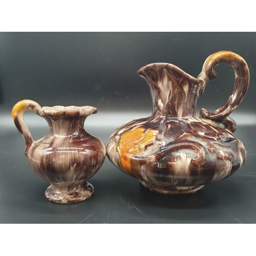 869 - A Pair of German Stoneware Jugs.  14 and 9cm