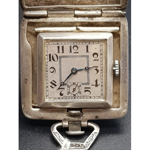 248 - A vintage, possibly antique swiss-made travelling clock in a silver case. AS found. 3 1/2 x 3 1/2 cm... 