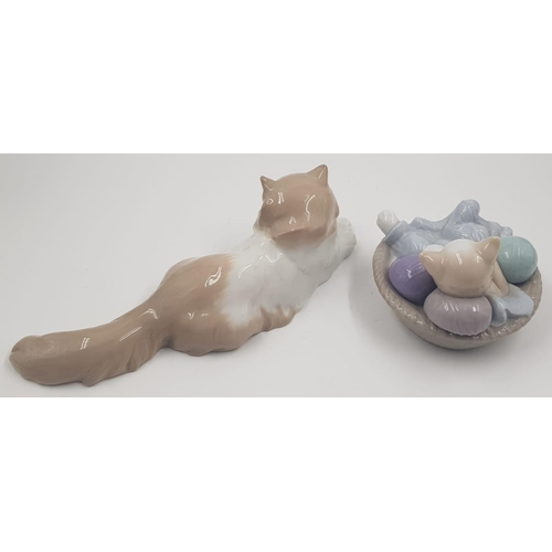 485 - A Pair of Lladro Figures. A cat at rest and a Cat at play.
12 and 26cm length.