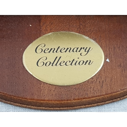 697 - The Centenary Collection from the Bradford Exchange. A wooden hanging display case that holds 25 min... 