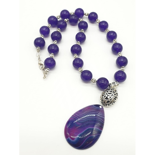 632 - A Tibetan silver with purple jade and agate necklace in a presentation box. Colour enhanced. Necklac... 