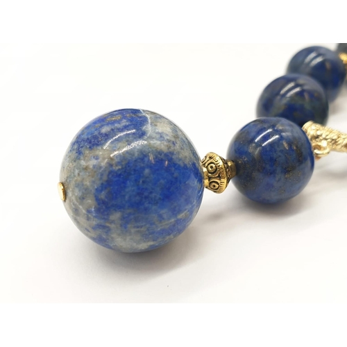 648 - A quality lapis lazuli necklace and earrings set in a presentation box. Necklace length: 49-53cm, ea... 