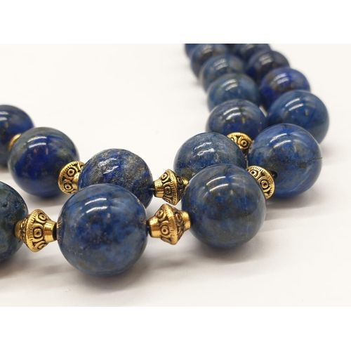 648 - A quality lapis lazuli necklace and earrings set in a presentation box. Necklace length: 49-53cm, ea... 