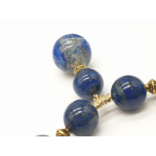 648 - A quality lapis lazuli necklace and earrings set in a presentation box. Necklace length: 49-53cm, ea... 