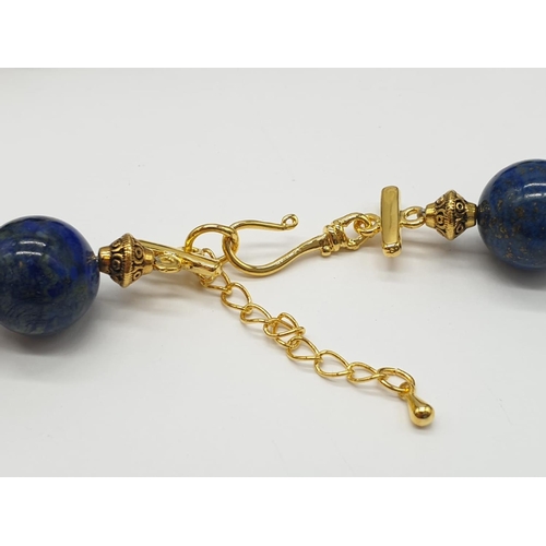 648 - A quality lapis lazuli necklace and earrings set in a presentation box. Necklace length: 49-53cm, ea... 