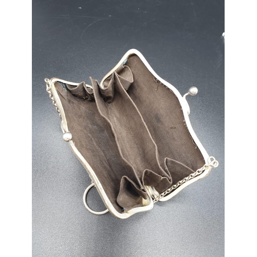 792 - An early white-metal elegant purse. Attached to a white-metal chain with cloth interior. 12 x 8cm. 1... 