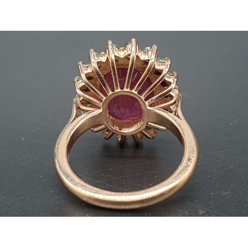 368 - A 9ct Ruby ring with a halo of emerald accents in 925 silver gold plating, weight 8g and size M1/2