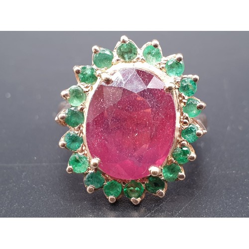 368 - A 9ct Ruby ring with a halo of emerald accents in 925 silver gold plating, weight 8g and size M1/2