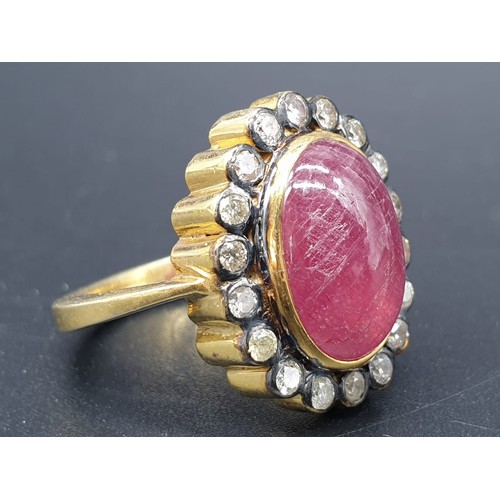 250 - A cabochon ruby gemstone ring with a halo of white diamond accents approx .40ct size O