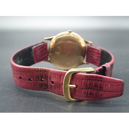 266 - An Accurist Shockmaster (21 jewels) gents watch with gilded bezel and back, 34 mm. Reddish brown sna... 