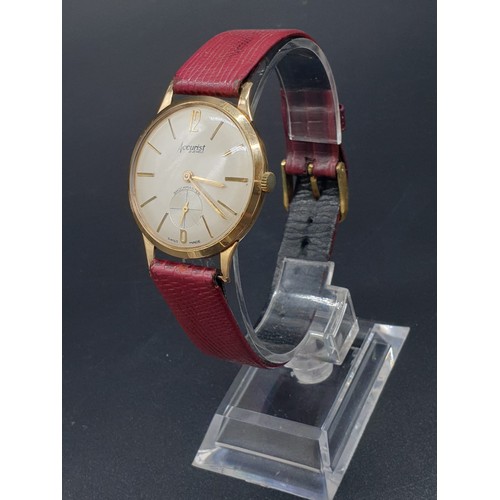 266 - An Accurist Shockmaster (21 jewels) gents watch with gilded bezel and back, 34 mm. Reddish brown sna... 