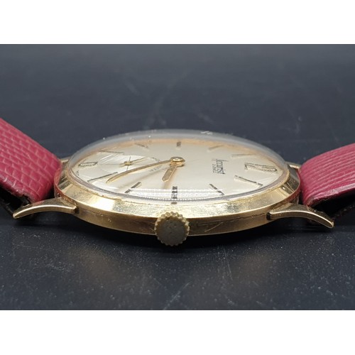 266 - An Accurist Shockmaster (21 jewels) gents watch with gilded bezel and back, 34 mm. Reddish brown sna... 