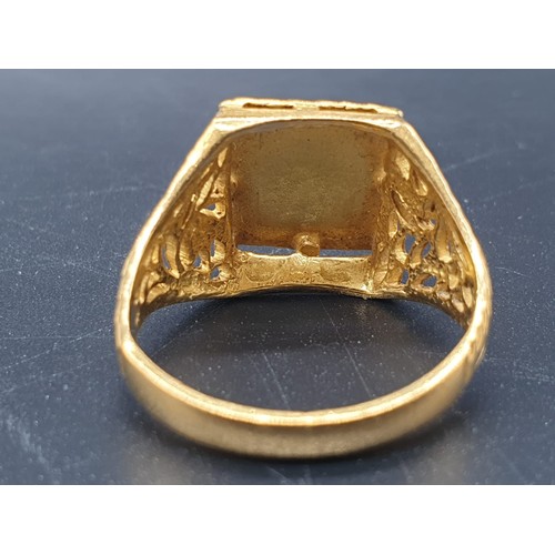 182 - A 22 carat yellow gold, gents ring, with square engraved crown and engraved and pierced shoulders, r... 