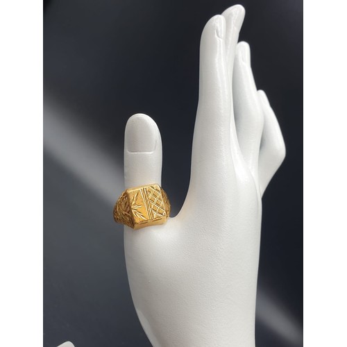 182 - A 22 carat yellow gold, gents ring, with square engraved crown and engraved and pierced shoulders, r... 