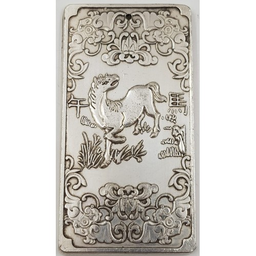 394 - A Chinese Silver Bullion Ingot depicting the Year of the Horse. 5 x 9.5cm. 134g.