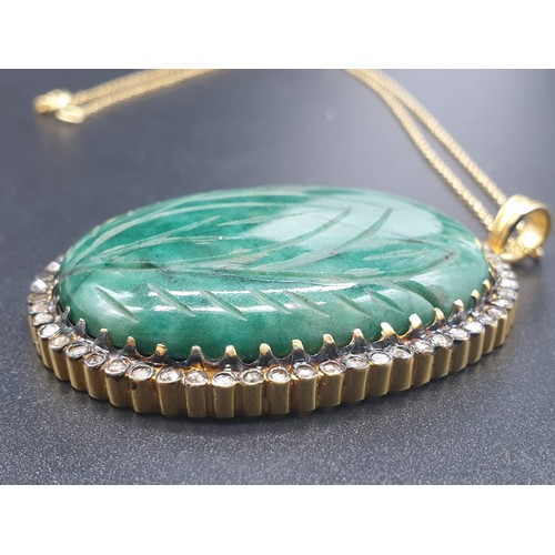 187 - A carved emerald Pendant with a halo of rose cut diamonds in pave setting in sterling silver with go... 