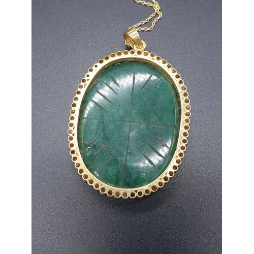 187 - A carved emerald Pendant with a halo of rose cut diamonds in pave setting in sterling silver with go... 