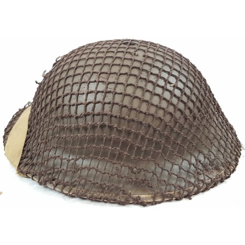 42 - 1939 Dated British Tommy Helmet with cam net & Shell Dressing Dated 1941.