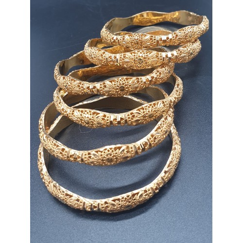 252 - An impressive set of six identical 21 carat yellow gold, heavily ornate, bracelets. Total weight: 96... 