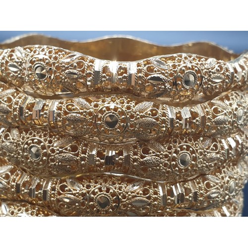 252 - An impressive set of six identical 21 carat yellow gold, heavily ornate, bracelets. Total weight: 96... 