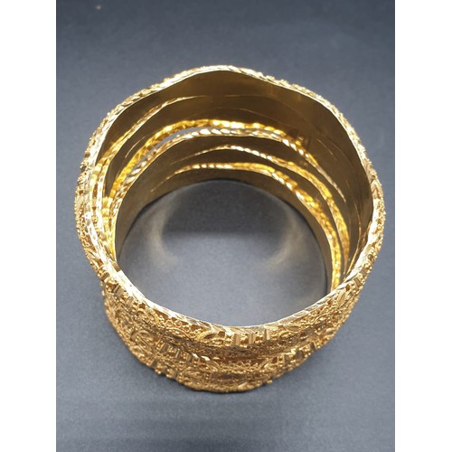 252 - An impressive set of six identical 21 carat yellow gold, heavily ornate, bracelets. Total weight: 96... 