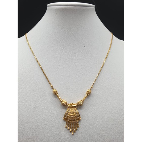 191 - A refined 21 carat yellow gold, Indian style chain with pendant. Chain length:  44cm, total weight: ... 