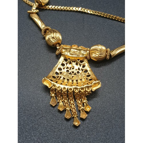 191 - A refined 21 carat yellow gold, Indian style chain with pendant. Chain length:  44cm, total weight: ... 