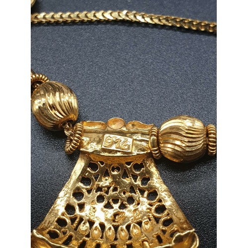 191 - A refined 21 carat yellow gold, Indian style chain with pendant. Chain length:  44cm, total weight: ... 