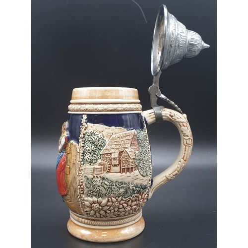 756 - A NICELY DECORATED BAVARIAN BEER STEIN WITH FLIP LID IN WHITE METAL.
21cms HIGH