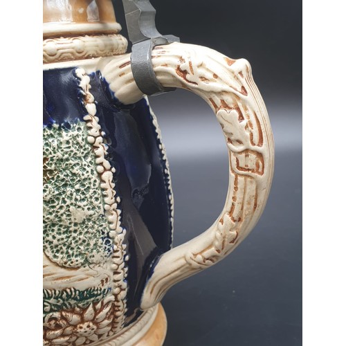 756 - A NICELY DECORATED BAVARIAN BEER STEIN WITH FLIP LID IN WHITE METAL.
21cms HIGH