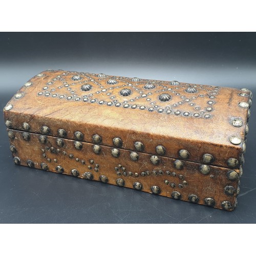 769 - AN ANTIQUE LEATHER BOUND STUDDED TRINKET BOX.
13 X 24CMS