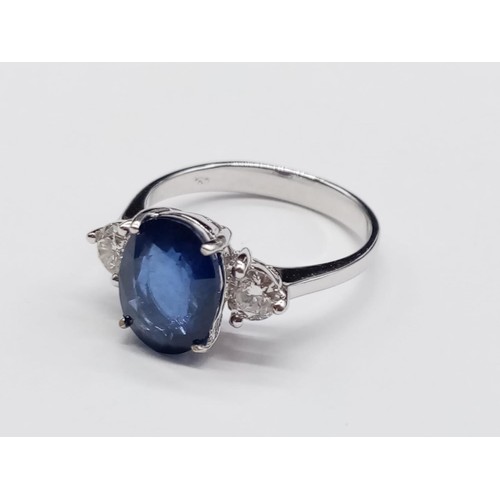 130 - 18ct White Gold RING set with one oval cut natural Sapphire and 2x round brilliant cut natural Diamo... 