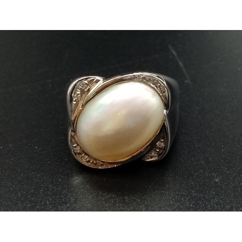 348 - 18ct White Gold RING with central Moonstone surrounded by small diamonds.   10.8g     Size: P